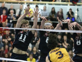 The trinity of blockers: Trinity Western's (left to right) Rudy Verhoeff, Dan Jansen van doorn and Steven Marshall were a brick wall when they had to be in CIS national semifinal win over Queen's. (Scott Stewart, TWU athletics)