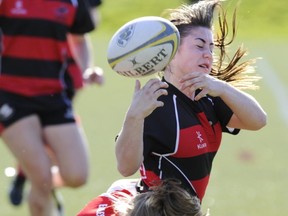 Abbotsford's Junnaya Murphy tries to break a Carson Graham tackle and come to grips with ball during B.C. 7's title game Saturday at UBC's Thunderbird Stadium. (Gerry Kahrmann, PNG photo)