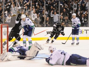 Los Angeles Kings players celebrate Dustin Brown's goal against the Vancouver Canucks in the third period at the Staples Center on Sunday, April 15, in Los Angeles, Calif. (MCT FILES)