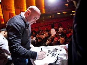 NEW YORK - MARCH 06: UFC president Dana White signs autographs for fans after a press conference at Radio City Music Hall on March 06, 2012 in New York City. UFC announced that their third event on the FOX network will take place on Saturday, May 5 from the IZOD Center in East Rutherford, N.J.. (Photo by Michael Nagle/Getty Images)
