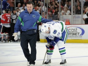 This was Daniel Sedin being helped off the ice on March 21, 2012, after taking an elbow to the head from the Chicago Blackhawks' Duncan Keith. Sedin has not played since. Getty Images file photo.