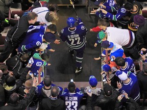 VANCOUVER, CANADA - APRIL 2: Daniel Sedin #22 of the Vancouver Canucks walks past fans out to the ice during their game against the Edmonton Oilers at Rogers Arena on April 2, 2011 in Vancouver, British Columbia, Canada. Edmonton won 4-1. (Photo by Jeff Vinnick/NHLI via Getty Images)