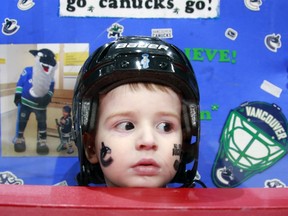 C'mon, people. This is a very cute photo of a very cute Canucks fan watching warmup before Game 5 of the Canucks-Kings series. Getty Images photo.