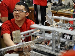 Timothy Leung, 15, of Gladstone Secondary School in Vancouver show off one of the robots that helped his team win first and second place at the VEX Robotics World Championship in California last week. (Jenelle Schneider/PNG FILES)