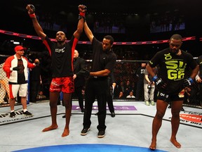 Rashad Evans can't bring himself to watch as Jon Jones raises his arms in victory following their UFC 145 showdown.