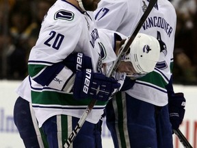 Sorry, no photo of the Lord of the Rings' Dwarf King here. But we did happen to find heavily bearded Chris Higgins and Ryan Kesler helping a wounded Mason Raymond off the ice in the final against Boston. Getty Images file photo.