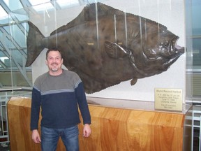 Martin Paish poses with a mount of the largest halibut ever caught, a nine-foot-five-inch long, 459-pound fish caught in 1996 by Jack Tragis in Unalaska, Alaska. (SUBMITTED PHOTO)