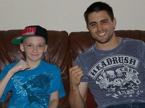 Max Hiler hanging out on the couch with interim UFC welterweight champion Carlos Condit on Friday. Max heads back to the hospital to undergo brain surgery on Monday. Keep fighting Max! (photo courtesy of Michelle Hiler)