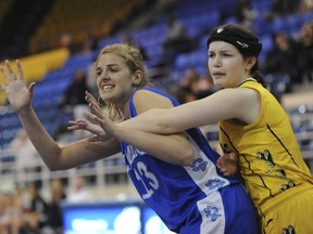Victoria-Lambrick Park's Tyger Holt (left) tries to seal Coquitlam-Gleneagle's Jamie McLaughlin during BC girls all-star game Saturday at War Gym. (Jason Payne, PNG)