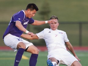 Simon Fraser Clan sophomore midfielder Jovan Blagojevic (right) battles with a Washington Huskies player during exhibition match Friday at Terry Fox Field. SFU beat the visiting Huskies 3-0 in its final spring match. (Ron Hole, SFU Athletics)