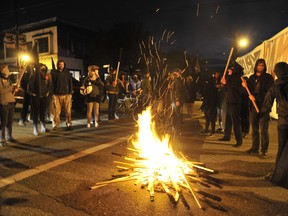 Radicals watch a May Day fire they ignited on Commercial Drive. (Ian Lindsay/PNG FILES)