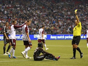 Vancouver Whitecaps' rookie Darren Mattocks sees yellow for embellishment against Colorado. A minute later, he'd be sent off. (Jeff Vinnick/Getty Images)