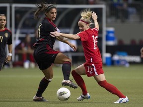 Canada's Kelly Parker battling against Mexico in the CONCACAF Olympic qualifiers. Parker's had surgery to remove her right meniscus but expects to be back in time for the London Games. (Photo by Rich Lam/Getty Images)