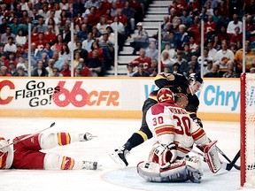 Pavel Bure, admitted Tuesday into the Hockey Hall of Fame, scores one his most memorable goals, slipping the puck past Calgary Flames goalie Mike Vernon in double overtime in the seventh and deciding game of the 1993-94 Western Conference quarter-final at the Saddledome. (Dean Bicknell/CALGARY FLAMES FILES)