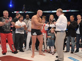 Russia's President Vladimir Putin (front R) congratulates heavyweight mixed martial artist Fedor Emelianenko (front L) after watching his fight against Pedro Rizzo entitled "M-1 Global: Fedor vs. Rizzo," at Ice Palace in Saint-Petersburg, late on June 21, 2012. (Photo credit ALEXEI NIKOLSKY/AFP/Getty Images)