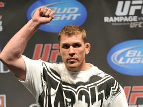 UFC heavyweight title contender Mike Russow rocks the scale the way I spend my days around the swimming pool: shirt on, minimal skin exposed. (Photo by Jon Kopaloff/Getty Images)