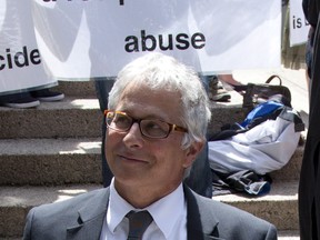 Joseph Arvay, lawyer for the B.C. Civil Liberties Association, is seen making his way past pro-life demonstrators outside the B.C. Supreme Court in Vancouver, on Friday, June 15, 2012. Arvay was the lead lawyer in the case that successfully challenged the law against assisted suicide. (CANADIAN PRESS FILES)