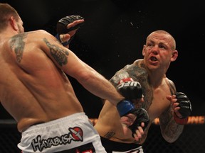 SYDNEY, AUSTRALIA - FEBRUARY 27: Ross Pearson of Great Britain punches Spencer Fisher of the USA during their Lightweight bout UFC 127 at Acer Arena on February 27, 2011 in Sydney, Australia. (Photo by Mark Kolbe/Getty Images)