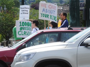 Teachers demonstrate at 16th Avenue and Arbutus Street in Vancouver on June 20 to mark the one-year anniversery of them being without a contract. (Steve Bosch/PNG FILES