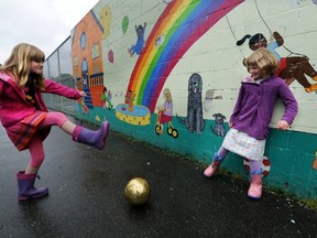 Madeleine Tempelman-Kluit, 8, and her sister Lucy, 6, play outdoors on a June day getting exercise that generations of moms would agree is better for kids than sitting around the house. (Steve Bosch/PNG FILES)