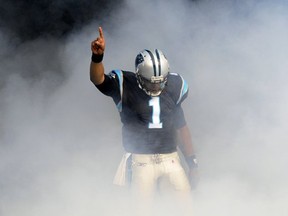 Carolina Panthers' Cam Newton gestures as he is introduced before an NFL football game against the Tampa Bay Buccaneers in Charlotte, N.C., Saturday, Dec. 24, 2011. (AP Photo/Mike McCarn)