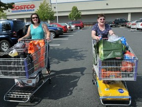 Samantha Jensen (left) and Carolyn Jensen discuss complaints by locals about Canadians shopping at Costco in Bellingham. (Wayne Leidenfrost/PNG)