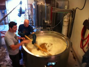 Howe Sound brewmaster Franco Corno (right) stirs the mash.