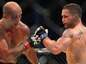 Former UFC lightweight champion Frankie Edgar (right) has officially announced he'll be moving down to featherweight. No date has been set for his debut. (Photo by KARIM SAHIB/AFP/Getty Images)