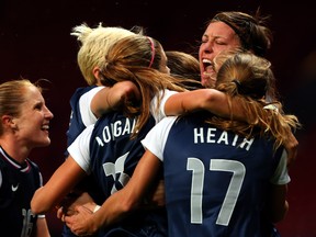 The American women swamp superstar Abby Wambach after the winning goal was scored in the USA's 4-3 win over Canada in the Olympic soccer tournament Monday. Getty Images photo.