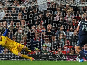 US forward Abby Wambach puts her penalty shot past Canada goalkeeper Erin McLeod during the Olympic women's soccer semifinal Monday. Getty Images Photo.