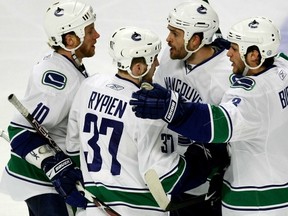 Happier times: Rick Rypien celebrates a Vancouver Canucks goal in the 2009 Stanley Cup playoffs with Darcy Hordichuk (third from left) and Kevin Bieksa (far right).