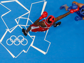 Boxers at center-ring at the London Olympics boxing venue ExCel.