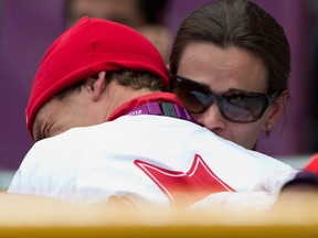 Simon Whitfield shares tough moment with his wife Jennie. CP Photo.