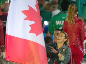 Canadian women's soccer team captain Christine Sinclair carries the Canadian flag into the closing ceremonies of Olympic Games in London on Sunday. (CANADIAN PRESS)