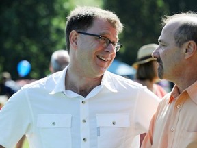 B.C. NDP leader Adrian Dix shares a laugh with Canadian Labour Congress head Ken Georgetti during Labour Day picnic at Trout Lake Park in Vancouver. (Ric Ernst/PNG FILES)