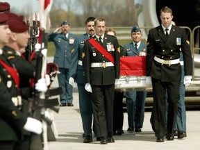 The casket of Canadian soldier Sgt. Marc Leger, one of four soldiers killed in an Afghanistan friendly fire incident, files pass an honour guard at CFB Trenton in 2002.