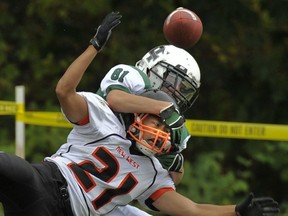 Lord Tweedsmuir's Cayden Helder makes life tough for New Westminster's Eric Teng (21) during conference opener for both teams Friday in Cloverdale. (Les Bazso, PNG)