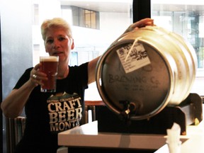 B.C. Craft Beer Month director Lundy Dale with her cask of blueberry/cranberry ESB