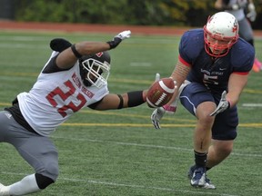 Simon Fraser middle linebacker Casey Chin closes in on loose ball and the outstretched arm of Western Oregon running back Kenneth Haynes during GNAC football game Saturday at Terry Fox Field. (Les Bazso, PNG)