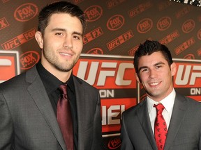 Carlos Condit (left) is the interim UFC welterweight champion, while UFC bantamweight champ Dominick Cruz watched an interim title be introduced in his division after he was injured. (Photo by Jason Merritt/Getty Images)
