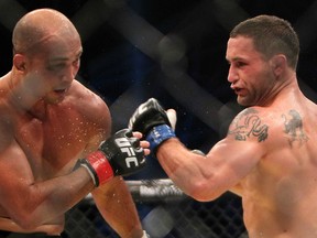 Frankie Edgar (R), shown here facing BJ Penn at UFC 112, could make his featherweight debut in a championship bout against Jose Aldo in January 2013 when the UFC returns to Brazil. (Photo by KARIM SAHIB/AFP/Getty Images)
