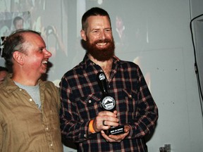 Steamworks' Conrad Gmoser receives the Best in Show trophy from B.C. Beer Awards co-founder Gerry Erith