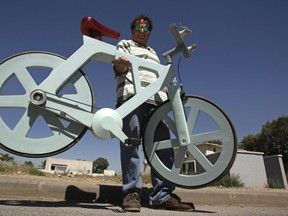 Izhar Gafni poses with the world's first cardboard bicycle which he developed. Tough, sturdy, green and cheap to build, the bike is slated for mass production in the next few months.
