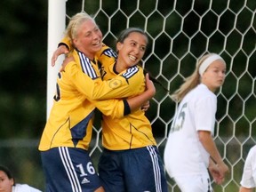 Trinity Western’s Kristen Santema (left) is congratulated by teammate Jennifer Castillo after Santema scored the first goal in her comeback from aplastic anemia, Sept. 29 against the Saskatchewan Huskies at Rogers Park in Langley. Santema missed the entire 2011 season to the condition but leads her team into the playoffs tonight against Manitoba. (Scott Stewart, Trinity Western athletics)