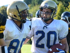 Seaquam Seahawks' running back Mark Lego (20), the leader in the B.C. Double A rushing race by almost 400 yards, shares a moment with teammate Jay Singh earlier this season, (Photo -- submitted)