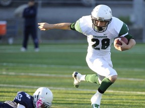 STRIKE A POSE... Lord Tweedsmuir's Taylor Anderson looks decidedly Heisman-esque as he breaks away from a Notre Dame tackler during Triple A encounter Friday at Burnaby Lakes. (Gerry Kahrmann, PNG)