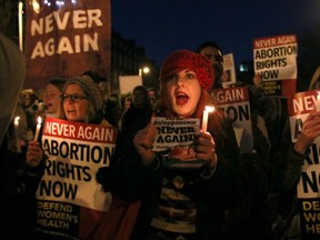 Demonstrators in Dublin hold placards and candles in memory of Savita Halappanavar, who died after being denied an abortion in Ireland that would have saved her from complication with her pregnancy, in support of legislative change to end Ireland's ban on abortion.  (AFP/GETTY IMAGES)