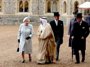 Prince Charles, who complains that people are consuming too many of the world's resources that will lead to environmental catastrophe, walks with Amir Sheikh Sabah Al-Ahmad Al-Jaber Al-Sabah of Kuwait, his mother Queen Elizabeth II, and his father, Prince Philip, among the world's wealthiest people, at Windsor Castle during a three-day state visit that will include a military parade at Royal Military Academy Sandhurst and a banquet.(GETTY IMAGES)