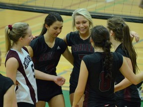 The Heritage Woods Kodiaks of Port Moody celebrate a point during four-set win Friday over North Vancouver's Argyle Pipers in the Sweet 16 round of the BC girls AAAA volleyball championships at Riverside Secondary in PoCo.