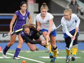 UBC's Natalie Sourisseau (centre) and Caitlin Evans dig in to pursue a loose ball as a member of the Western Nustangs goes airborne Saturday in CIS round-robin match. UBC plays for a national title Sunday. (Blair Shier, CIS)